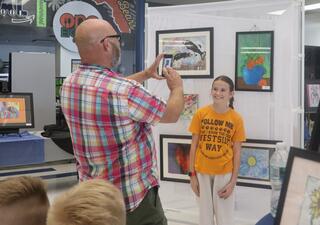 Father photographing daughter