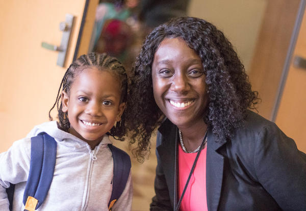 Principal Jasmine Brown posing for a photo with a student outside Giffen.