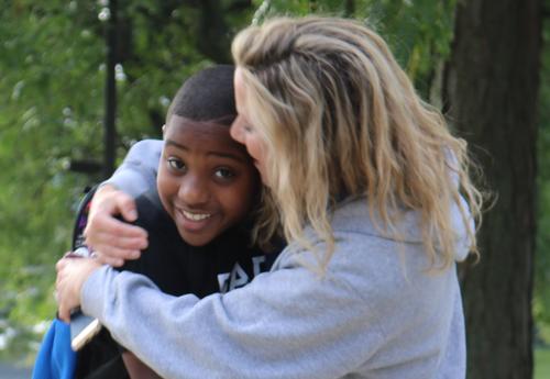 Arbor Hill teacher hugs returning student on first day.