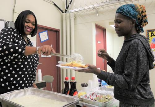 And Arbor Hill Elementary staff members serves a parent breakfast.