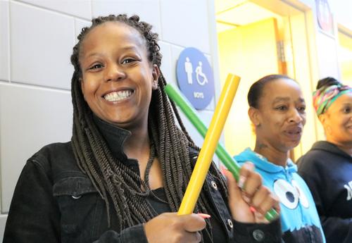 Sheridan Preparatory Academy staff members cheers for students as they walk to class.