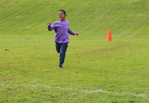 A first grade boy particpates in a running race at Arbor Hill Elementary School.