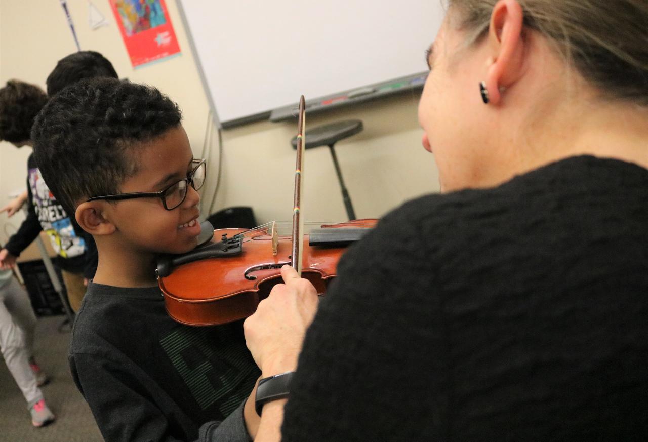 Strings players guide students Montessori School