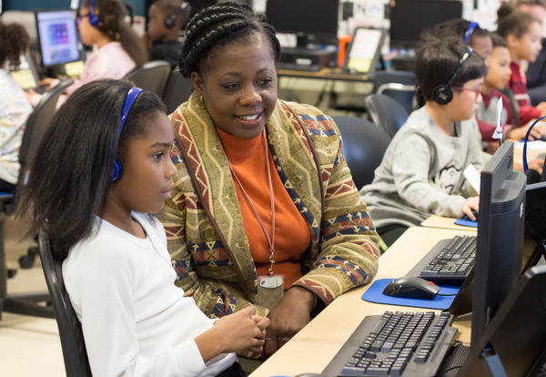 Superintendent Adams and girl work on computer together