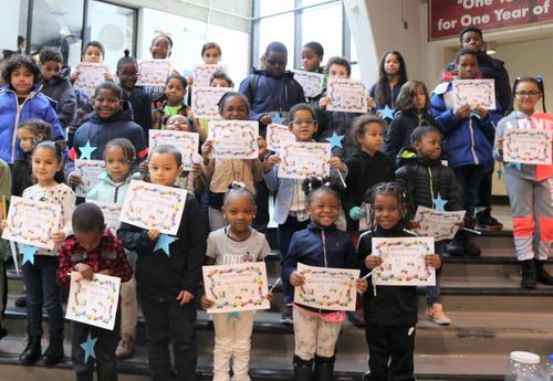 A group of Arbor Hill Elementary School students pose with their honor roll certificates.