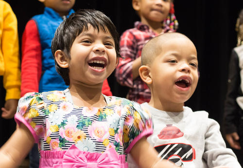 Two children sing holiday songs