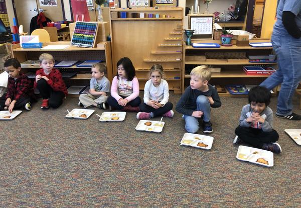 Students sample latkes during a lesson about Hanukkah.