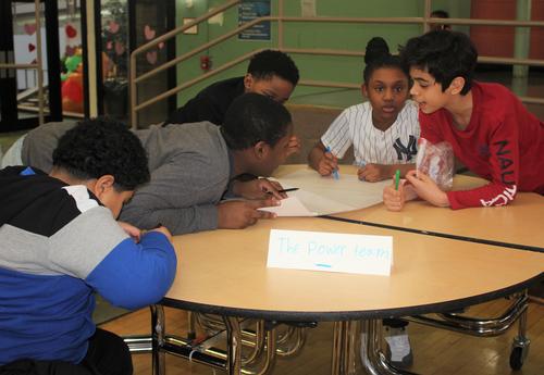 Students work on math problems together in a competition.