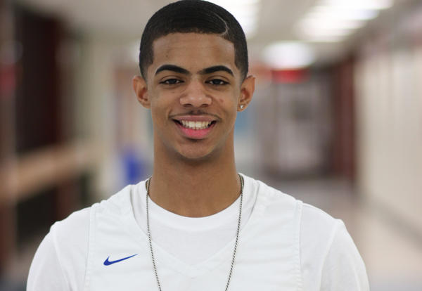 A boy's basketball player poses at Albany High