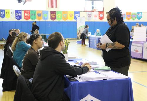 A parent visits with a community partner at the ASH resource fair.