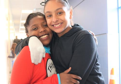 Two students dress up like Dr. Seuss characters during literacy week.