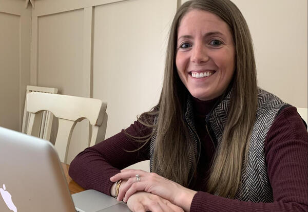 Albany High School teacher Arielle Joyce at a table with a laptop computer