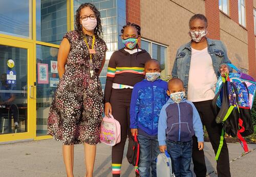 Principal Gayle welcomes a family to Sheridan Prep on the first full day of on-site instruction.