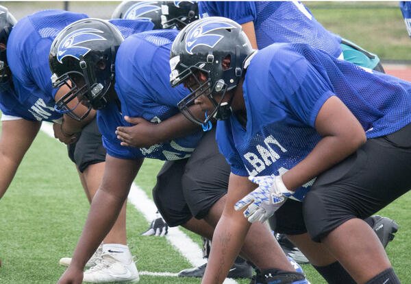 Albany High offensive linemen at the line of scrimmage.