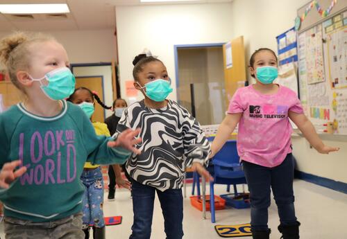 Three students dance as part of a "brain break."