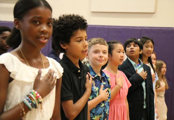 Students say the Pledge of Allegiance during Montessori's Moving Up Ceremony.