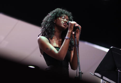 Student singing into a microphone