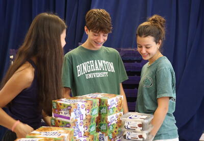 Student volunteers sort packaged food