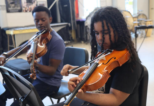 Teacher and student practice viola scales together