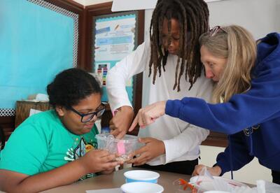 Students participate in a science lab during summer school at Hackett.