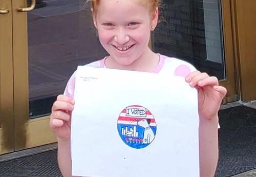 A fifth grader displays the art work she submitted to the 鶹Ӱ Board of Elections.