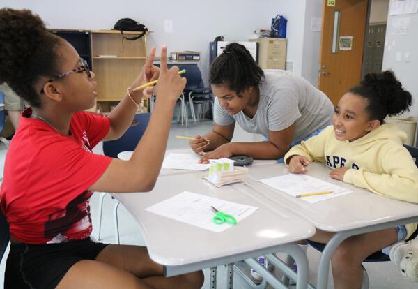 Students create vehicles to transport eggs down an incline.