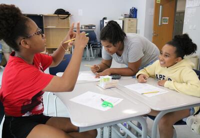 Students create vehicles to transport eggs down an incline.