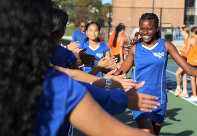 Girls' tennis athletes getting ready to take the court