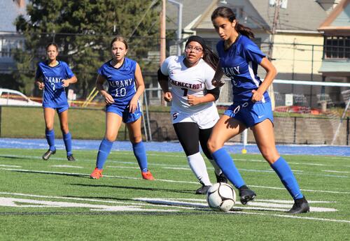 Members of the Albany High girls' soccer team compete in a game in September 2024