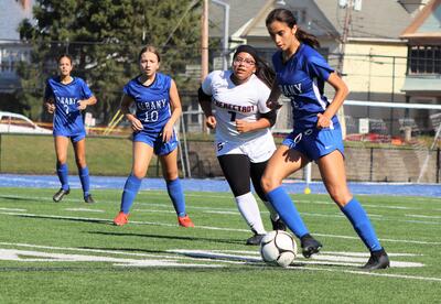 Members of the Albany High girls' soccer team compete in a game in September 2024