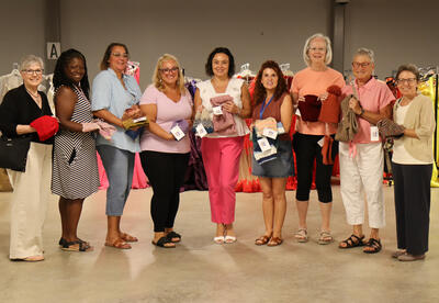 Albany High principal Jodi Commerford, Albany High staff and Chicks with Sticks of Glenmont NY members holding up donations