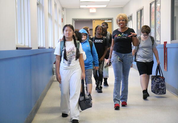 A sixth grade class gets a tour of their new school.