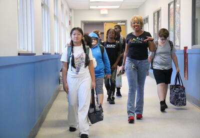 A sixth grade class gets a tour of their new school.