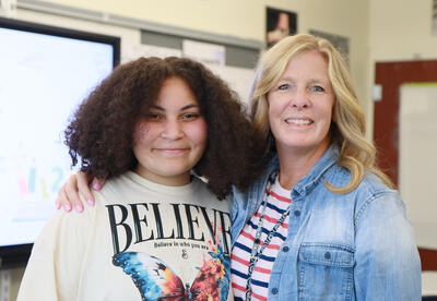 Student and teacher hug
