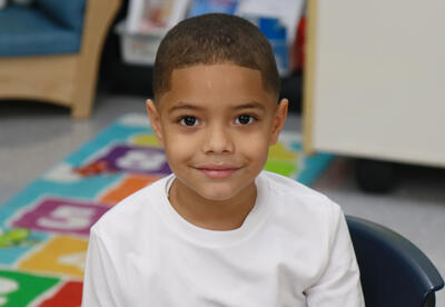 Smiling student sits at desk