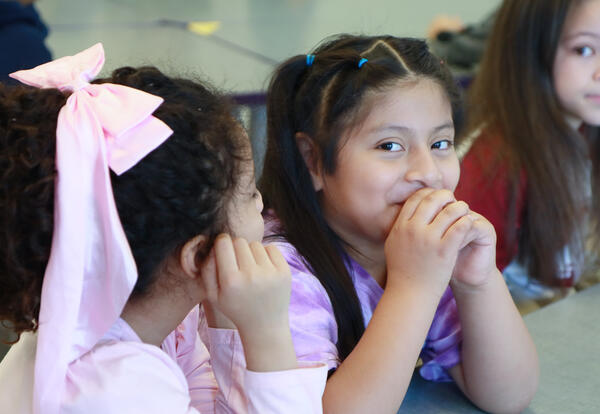 Two students laugh together