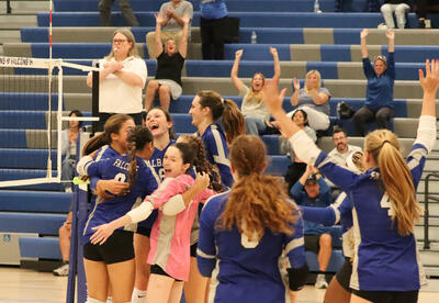 Team celebrating on the court after the game winning point