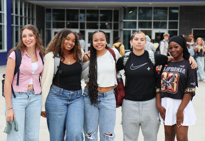 Group of five students outside of Albany High before the start of the school day