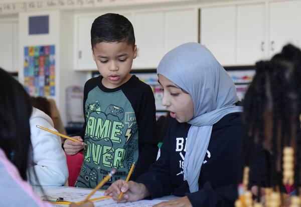 Two students work on a puzzle together