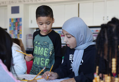 Two students work on a puzzle together