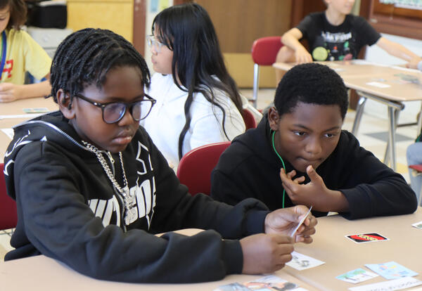 Two students mull over photos