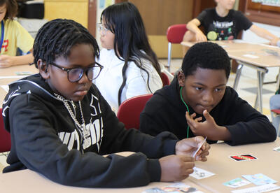 Two students mull over photos