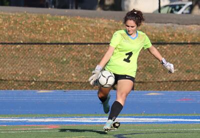 Goalie Maria Marcou-O'Malley kicking the ball back into play