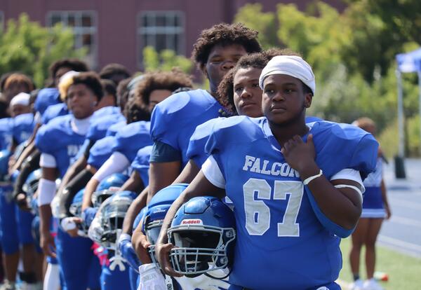 Albany High football players lined up on the sideline before the Sept. 20, 2025 game against Schenectday