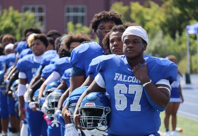 Albany High football players lined up on the sideline before the Sept. 20, 2025 game against Schenectday