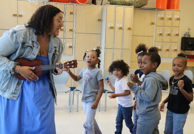 Students dance and sing in music class.