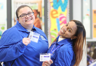 Two hall monitors smiling