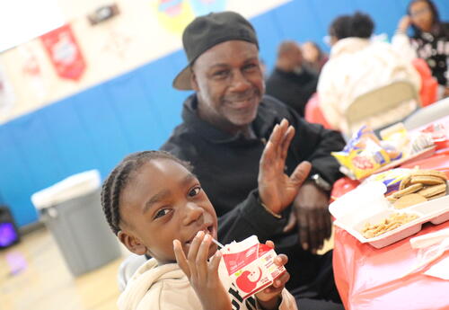 A father and son enjoy breakfast together.