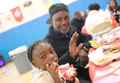 A father and son enjoy breakfast together.