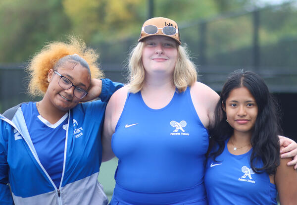 Girls' tennis seniors posing for a photo